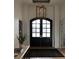 Grand foyer features a dark wood double door with glass panes, a dark rug, and modern lighting at 1610 Brock Ct, Las Vegas, NV 89117