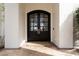 Elegant entryway features a dark wood double door with glass panes and a neutral woven mat at 1610 Brock Ct, Las Vegas, NV 89117