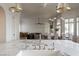 A bright, open kitchen featuring a marble island and views into the living and dining areas at 1610 Brock Ct, Las Vegas, NV 89117