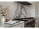 Close-up of stove with marble backsplash, countertops and stainless steel appliances at 1610 Brock Ct, Las Vegas, NV 89117