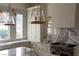 Gourmet kitchen featuring a marble backsplash, stainless steel appliances, and hanging lights at 1610 Brock Ct, Las Vegas, NV 89117