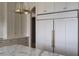 Spacious kitchen with a large refrigerator, neutral cabinets, and gold hardware at 1610 Brock Ct, Las Vegas, NV 89117