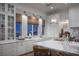 Bright kitchen features white cabinetry, marble countertops, pendant lighting, and stainless steel appliances at 1610 Brock Ct, Las Vegas, NV 89117