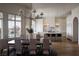 Open-concept kitchen and dining area with marble countertops, bar seating, and stainless-steel appliances at 1610 Brock Ct, Las Vegas, NV 89117