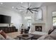 Bright living room features a fireplace, large mirror, and comfortable seating with a view of the outdoors at 1610 Brock Ct, Las Vegas, NV 89117