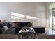 Comfortable living room with a large sectional sofa, stylish coffee table, and natural light at 1610 Brock Ct, Las Vegas, NV 89117