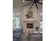 Bright living room features a fireplace, a ceiling fan, and sliding door to the backyard at 1610 Brock Ct, Las Vegas, NV 89117