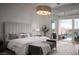Bright main bedroom with a king bed and views of the backyard pool and water slide at 1610 Brock Ct, Las Vegas, NV 89117