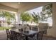 Outdoor dining area with built-in grill and a shaded patio overlooking the backyard at 1610 Brock Ct, Las Vegas, NV 89117