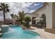 Gorgeous backyard pool and tanning deck overlooking the landscaping and neighborhood beyond at 1610 Brock Ct, Las Vegas, NV 89117