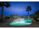 Backyard pool with water features illuminated against a night sky at 1610 Brock Ct, Las Vegas, NV 89117