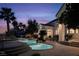 Stunning outdoor pool with grotto, spa, lush landscaping, and spacious seating for entertaining guests at 1610 Brock Ct, Las Vegas, NV 89117