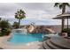 Beautiful backyard pool featuring a slide, a waterfall, and lush tropical landscaping at 1610 Brock Ct, Las Vegas, NV 89117