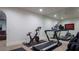 Home gym with exercise equipment, including a treadmill and stationary bike, and mirrored wall at 1610 Brock Ct, Las Vegas, NV 89117