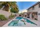 Backyard pool and hot tub offer a serene retreat, complemented by lush landscaping and privacy walls at 1721 Sweet Pea Ave, Las Vegas, NV 89183