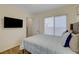 This bedroom features a large window, and flat screen TV with cozy decor at 1721 Sweet Pea Ave, Las Vegas, NV 89183