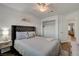 This bedroom has a closet, light-toned wood-look flooring and a dark tufted headboard at 1721 Sweet Pea Ave, Las Vegas, NV 89183