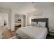 Comfortable bedroom with decorative pillows, stylish headboard, mirrored closet and warm wood floors at 1721 Sweet Pea Ave, Las Vegas, NV 89183