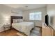 Bedroom featuring a soft rug, comfortable bed, and a window with natural sunlight at 1721 Sweet Pea Ave, Las Vegas, NV 89183