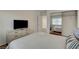 Inviting bedroom with a comfortable bed, mirrored closet, and a dresser with mounted television at 1721 Sweet Pea Ave, Las Vegas, NV 89183