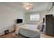 Bright bedroom with comfortable bed, wood-look flooring, and a TV on the dresser at 1721 Sweet Pea Ave, Las Vegas, NV 89183