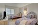 Charming bedroom featuring two twin beds, a modern dresser with television, and natural light from a window at 1721 Sweet Pea Ave, Las Vegas, NV 89183