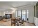 Dining area features a view of outdoor pool, contemporary table set, and cozy fireplace nearby at 1721 Sweet Pea Ave, Las Vegas, NV 89183