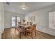 Dining room with a wooden table, bench seating, and natural light from the backyard at 1721 Sweet Pea Ave, Las Vegas, NV 89183