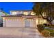 Two story home featuring a three-car garage, tile roof, and manicured lawn with mature tree at 1721 Sweet Pea Ave, Las Vegas, NV 89183