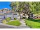 Charming single-Gathering home showcasing mature landscaping and a beautiful, shaded front yard at 1721 Sweet Pea Ave, Las Vegas, NV 89183