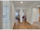 Hallway with doors leading to bedrooms with a view of the wooden look floor at 1721 Sweet Pea Ave, Las Vegas, NV 89183