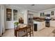 Modern kitchen boasts white cabinets, stainless appliances, and convenient access to the dining space at 1721 Sweet Pea Ave, Las Vegas, NV 89183