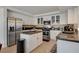 Well-equipped kitchen with white cabinets, granite countertops, and stainless steel appliances at 1721 Sweet Pea Ave, Las Vegas, NV 89183