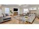 Bright living room features hardwood floors, sectional sofa, and entertainment center with large TV at 1721 Sweet Pea Ave, Las Vegas, NV 89183