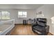 Spacious living area with hardwood floors, a comfortable leather recliner, and ample natural light at 1721 Sweet Pea Ave, Las Vegas, NV 89183