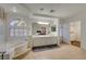 Bright main bathroom showcasing double sinks, large bathtub, and a closet at 1721 Sweet Pea Ave, Las Vegas, NV 89183