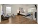 Bright main bedroom featuring hardwood floors, a sitting area, and a king bed at 1721 Sweet Pea Ave, Las Vegas, NV 89183
