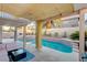 Relaxing covered patio with a clear pool, tropical plants, and privacy walls at 1721 Sweet Pea Ave, Las Vegas, NV 89183