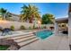 Stunning backyard pool and spa combination with surrounding patio and lush greenery offers a relaxing outdoor escape at 1721 Sweet Pea Ave, Las Vegas, NV 89183