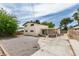 The spacious backyard features a mix of landscaping, a covered patio, and mature trees at 1806 Renada Cir, North Las Vegas, NV 89030
