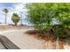 The backyard offers ample space with crushed rock and the shade of a large tree at 1806 Renada Cir, North Las Vegas, NV 89030