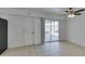 Finished basement area featuring neutral tile flooring, ceiling fan, and sliding door to backyard at 1806 Renada Cir, North Las Vegas, NV 89030