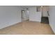 Finished basement area featuring neutral tile flooring, ceiling fan, and staircase at 1806 Renada Cir, North Las Vegas, NV 89030