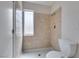 Bathroom showcasing a tiled shower with glass door, and a white toilet at 1806 Renada Cir, North Las Vegas, NV 89030