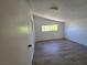 Bright bedroom with wood-look flooring, closet, and natural light at 1806 Renada Cir, North Las Vegas, NV 89030