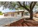 Charming two-story home featuring a two-car garage, mature landscaping, and inviting curb appeal at 1806 Renada Cir, North Las Vegas, NV 89030
