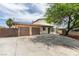 Single-story home featuring a two-car garage, stone accents, and mature landscaping at 1806 Renada Cir, North Las Vegas, NV 89030