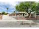 Charming single-story home featuring a two-car garage, gated entry, and mature tree at 1806 Renada Cir, North Las Vegas, NV 89030