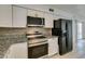 This kitchen features granite countertops, updated appliances, and stainless steel appliances at 1806 Renada Cir, North Las Vegas, NV 89030