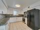 This kitchen features granite countertops and black appliances at 1806 Renada Cir, North Las Vegas, NV 89030